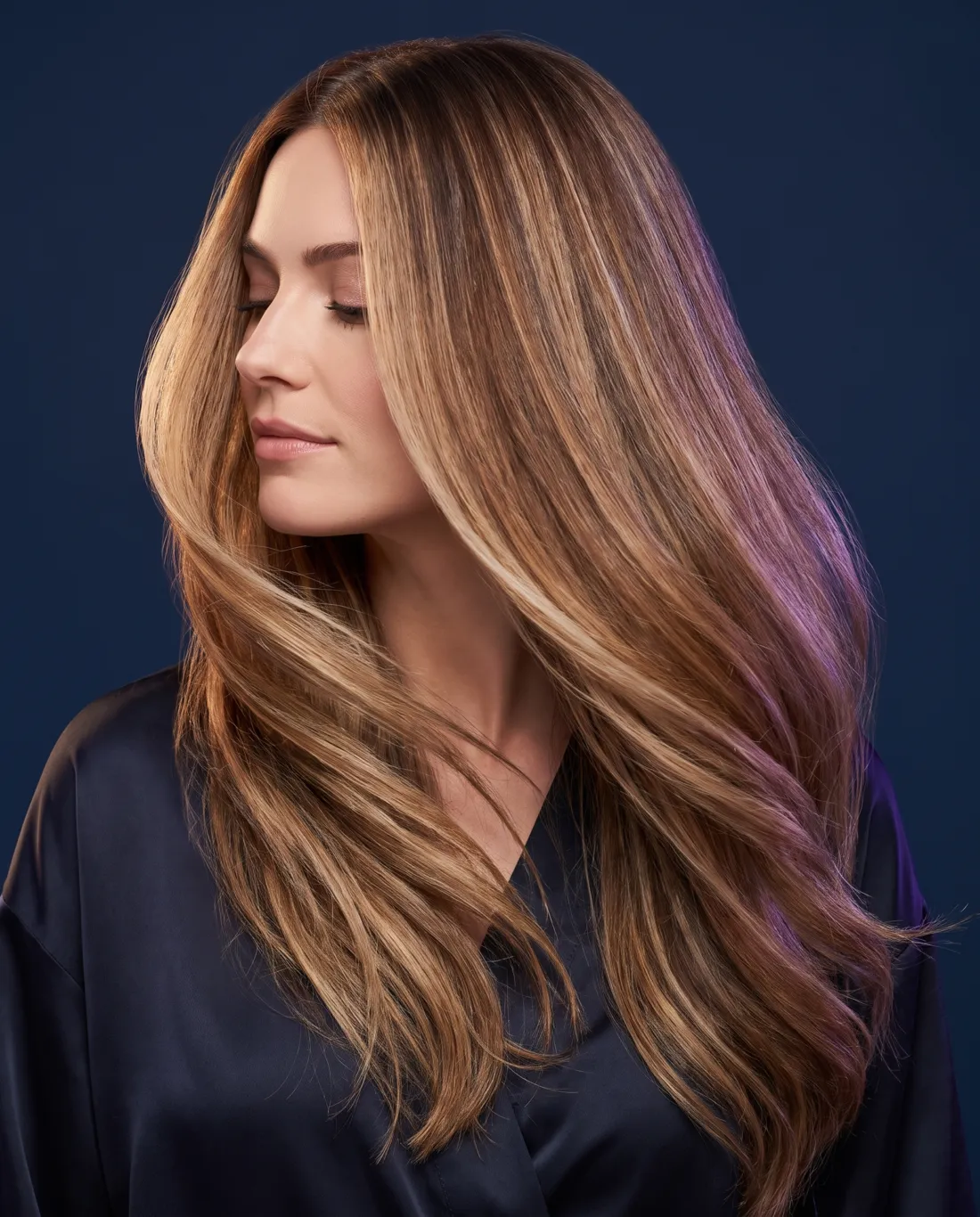 Concept example: glossy balayage hair in motion against a navy backdrop